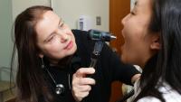 Dr. Anca D. Askanase examining a patient.
